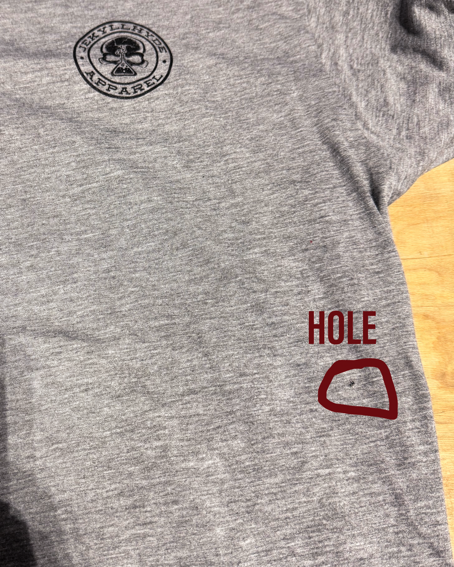 Flat lay of Jekyllhyde Vulture tee with a small hole in the left abdomen area.  