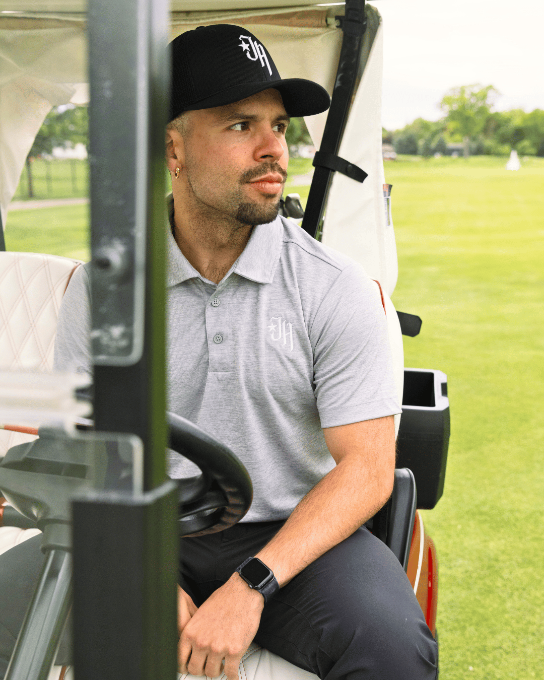 Man sitting in a golf cart on a golf course
