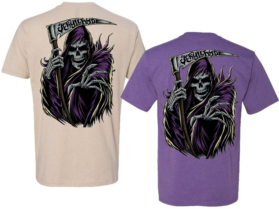 Two short-sleeve graphic T-shirts shown side by side on a white background, displaying the back designs. The left shirt is beige and the right shirt is purple, both featuring a large graphic of a grim reaper in a purple cloak holding a scythe with the word 'Jekyllhyde' on the blade.