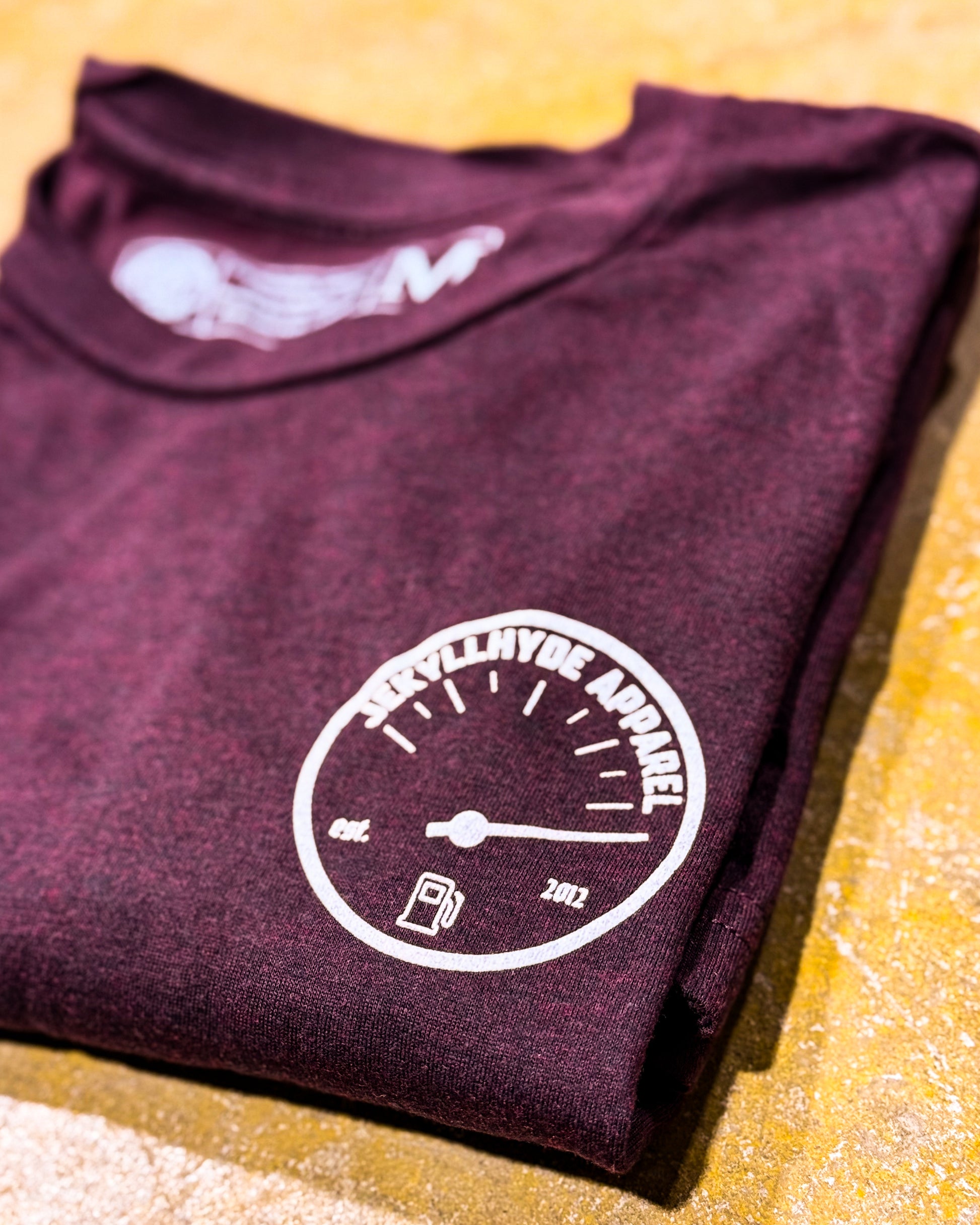 Folded tshirt with fuel gauge logo on left chest 