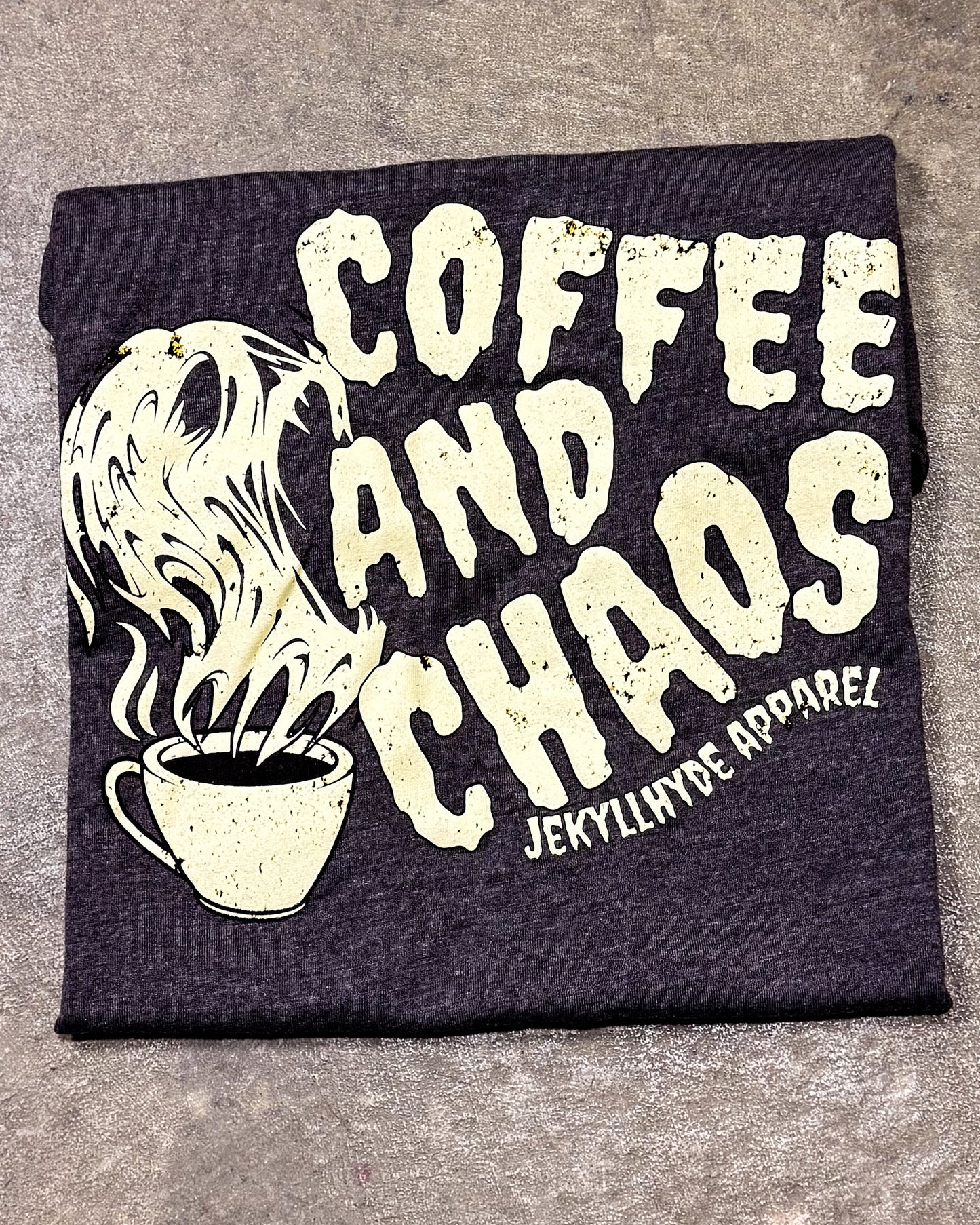 Black t-shirt with 'Coffee and Chaos' text and a coffee cup graphic on a gray background
