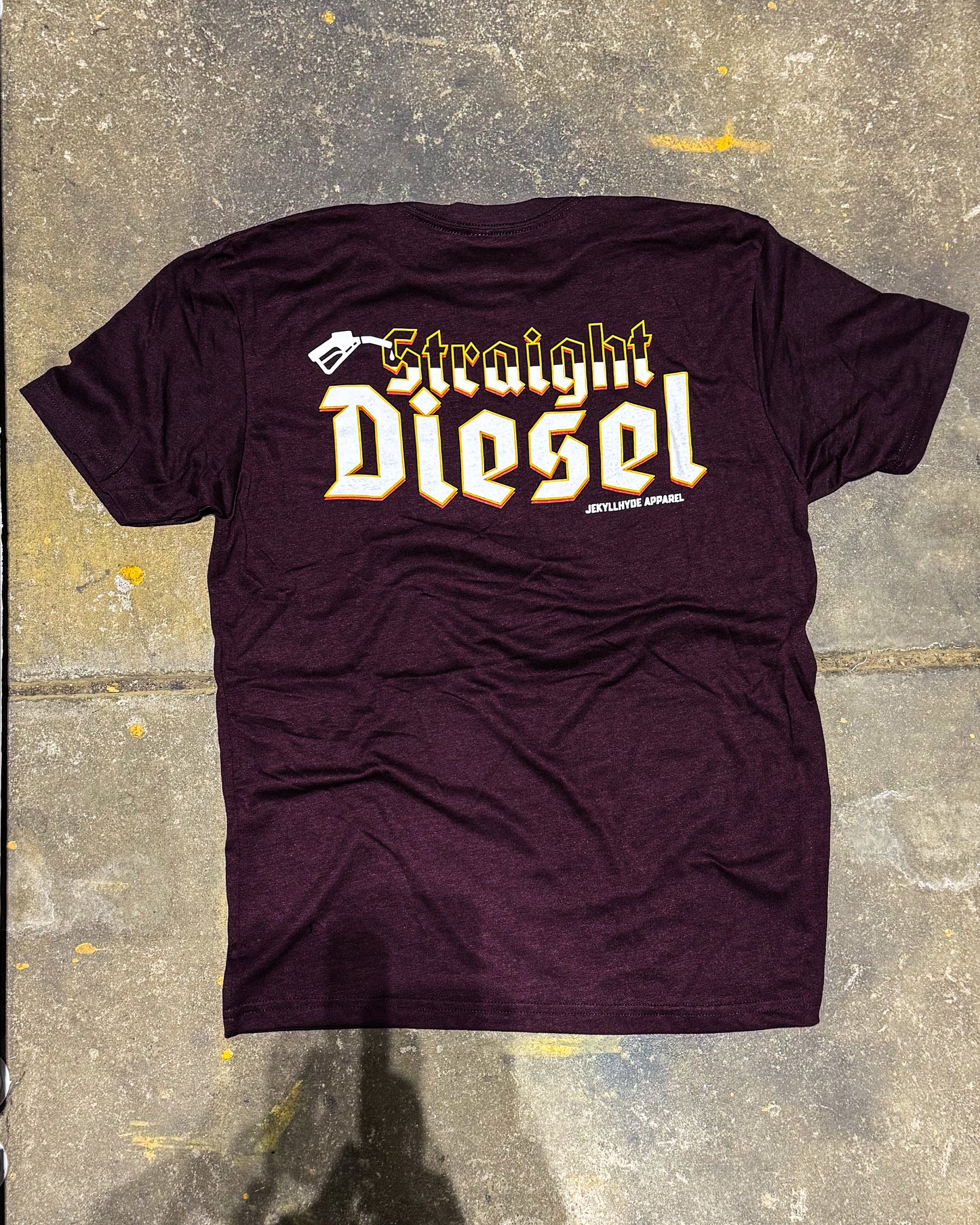 Flat lay of maroon tshirt with the words "straight Diesel" on it. 