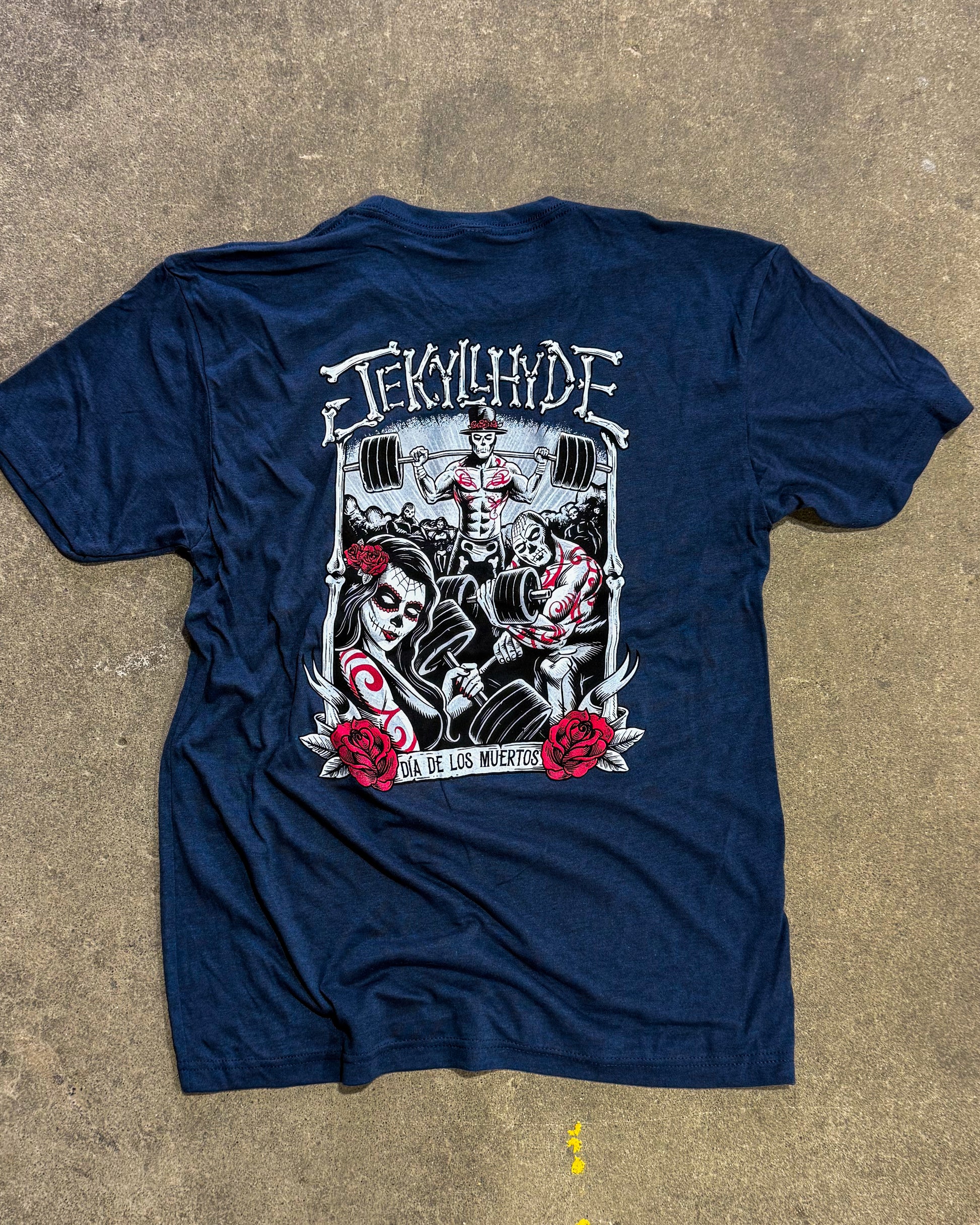 Navy blue t-shirt with graphic design on a concrete surface