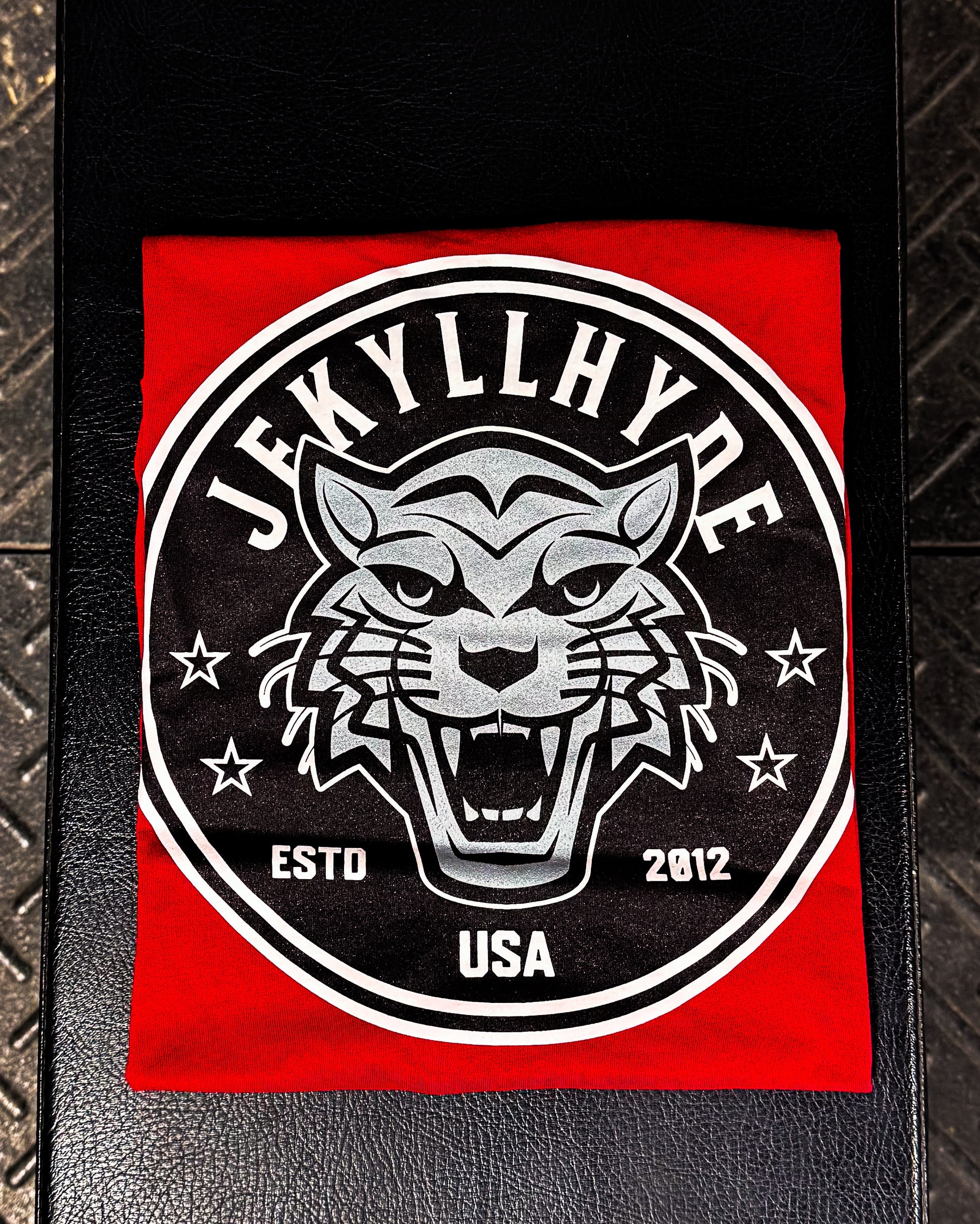 Jekyllyhyde logo with a wildcat design on a red t-shirt and black background