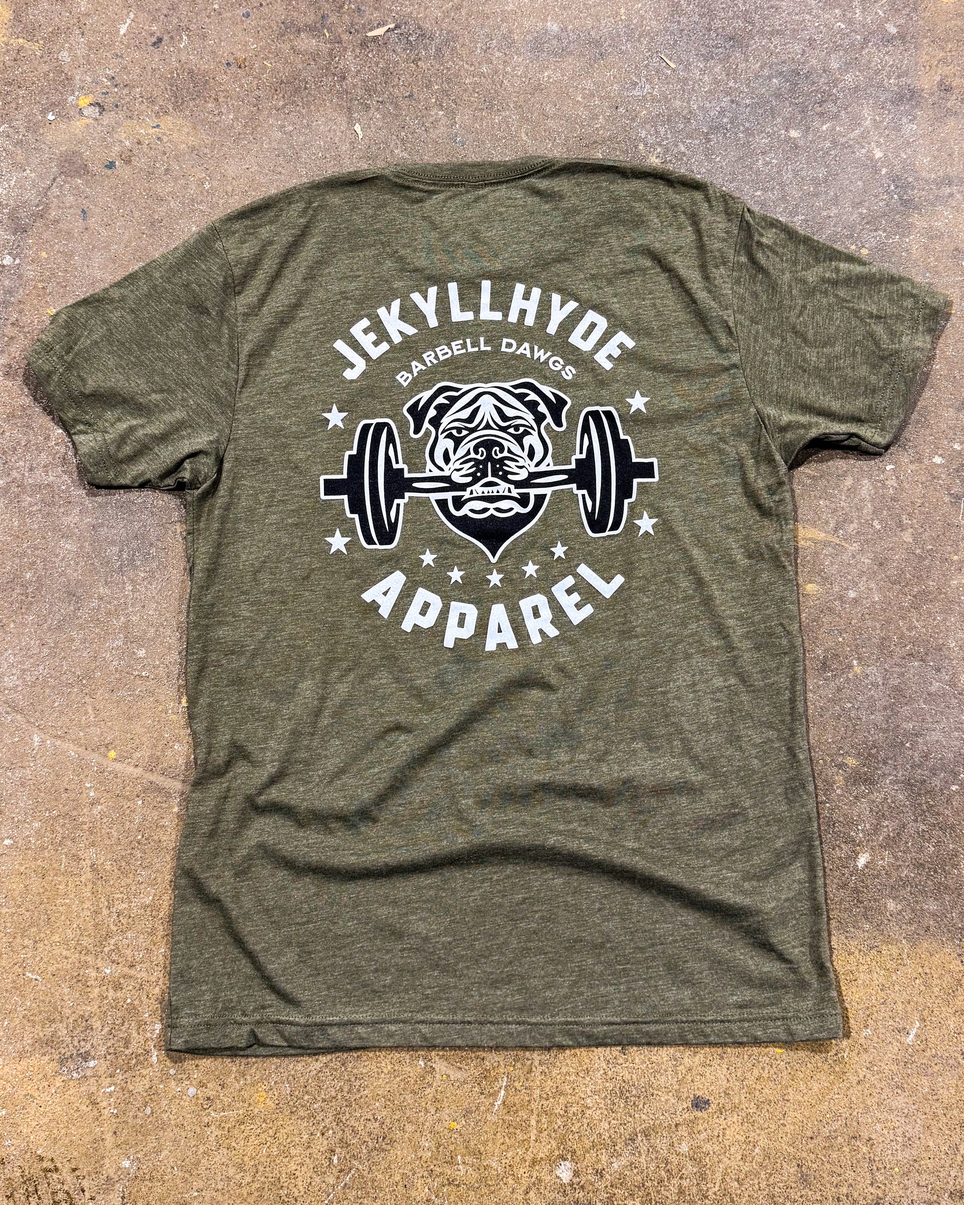 Green t-shirt with 'Jekyll Hyde Apparel' logo featuring a bulldog lifting weights on a textured surface.