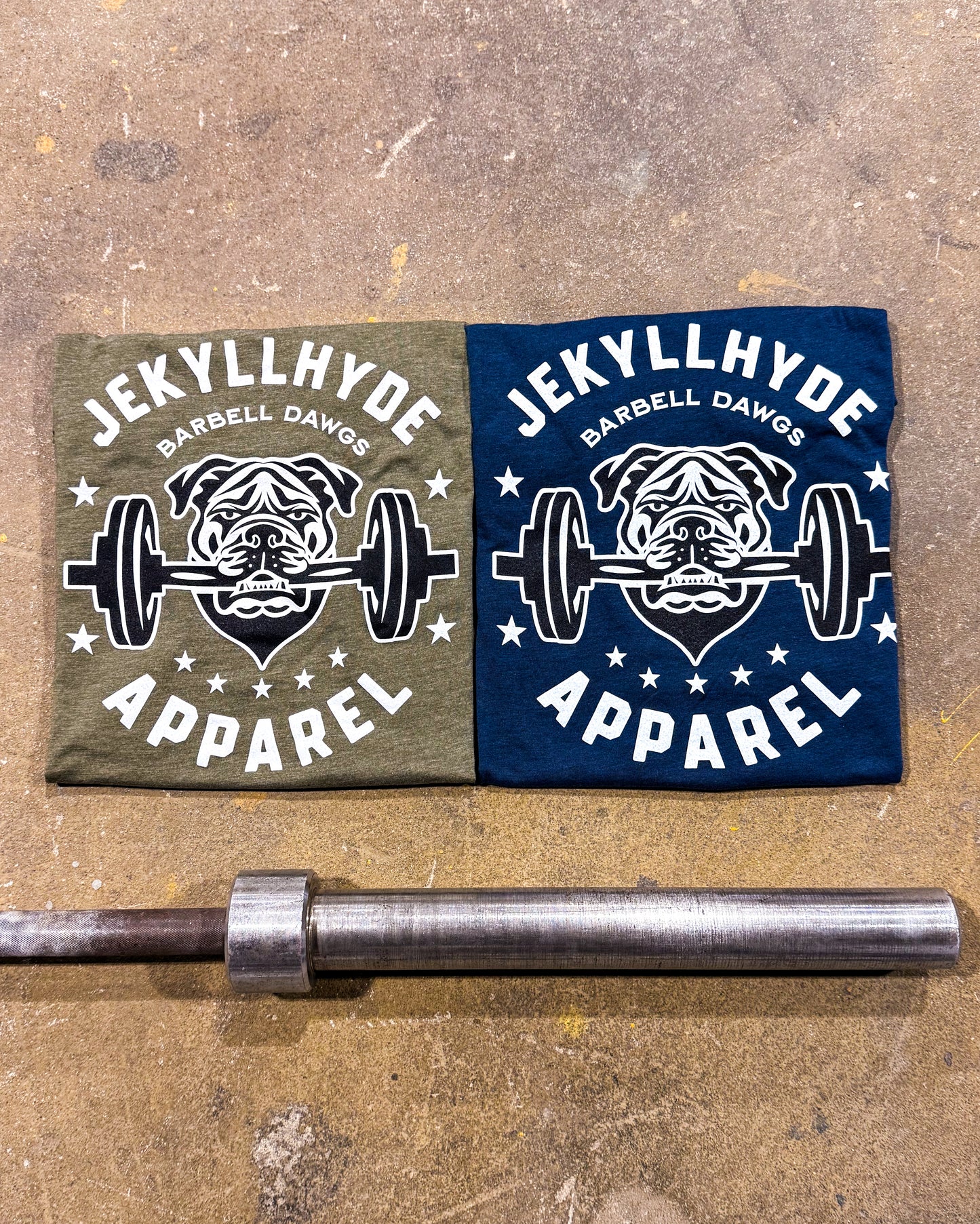 Two t-shirts with 'Jekyll Hyde Apparel' logo on a metallic barbell.