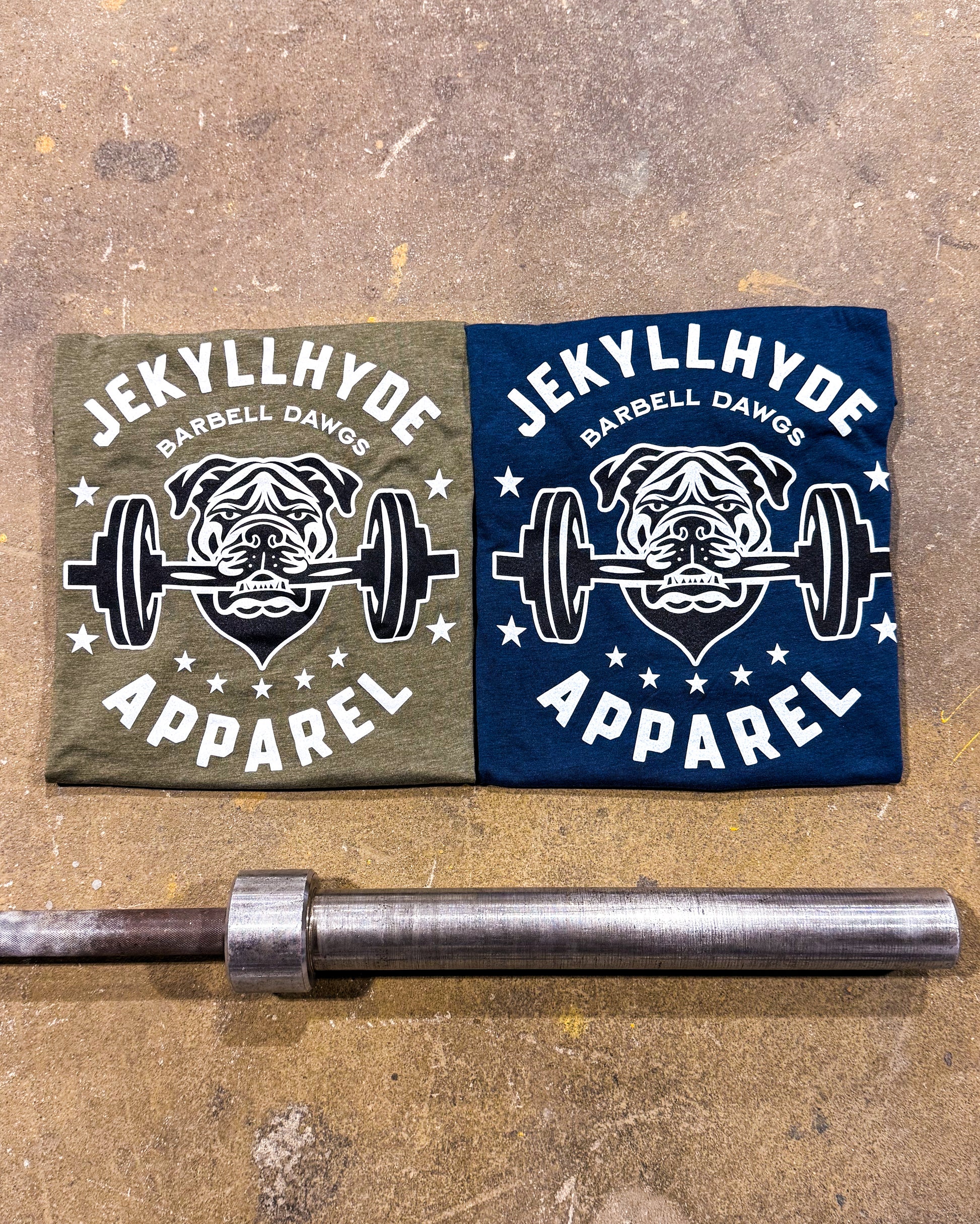 Two t-shirts with 'Jekyll Hyde Apparel' logo on a metallic barbell.