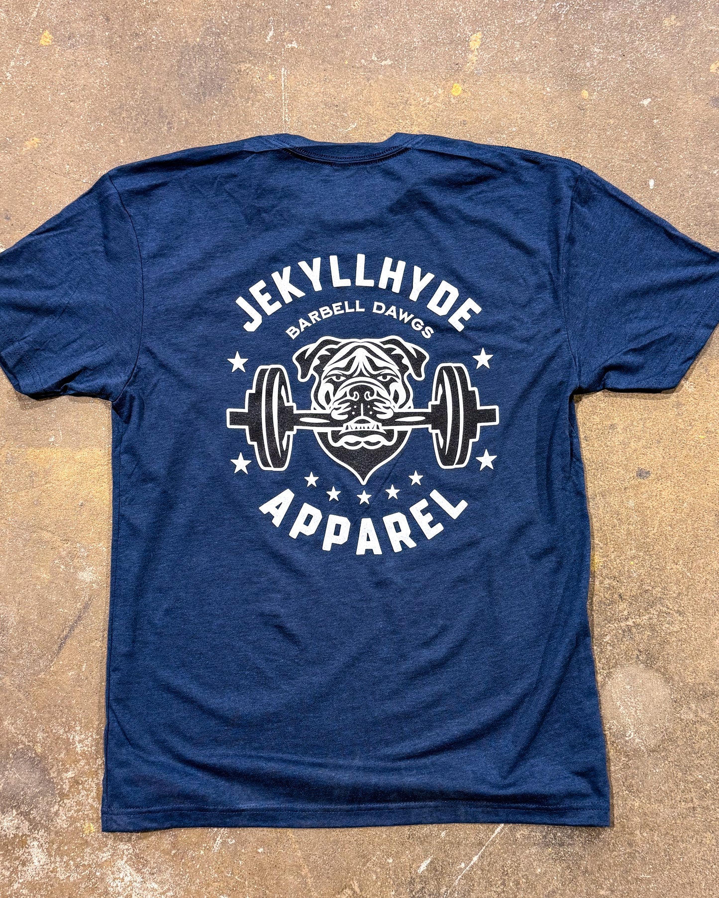 Blue t-shirt with 'Jekyll Hyde Barbell Dawgs Apparel' graphic on a textured surface