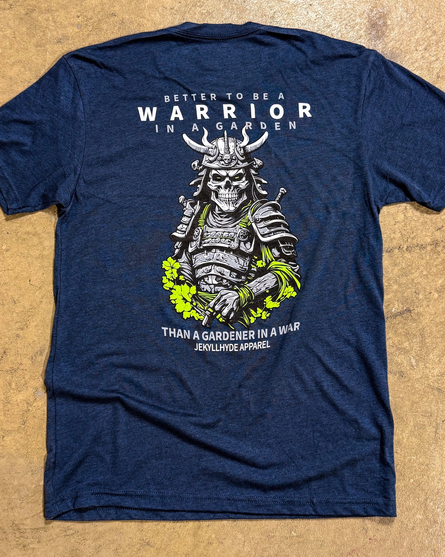 Blue t-shirt with a warrior graphic and text on a beige background