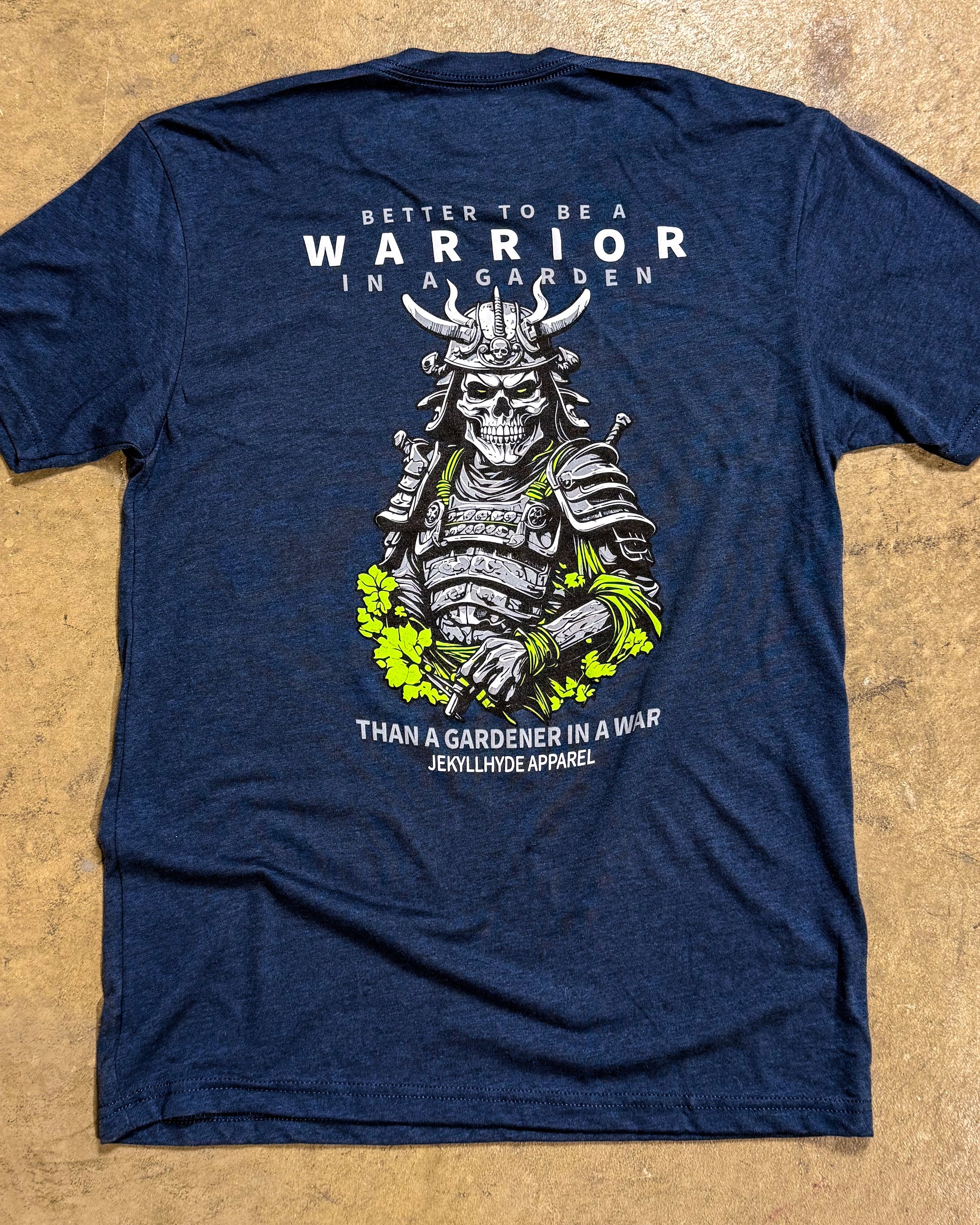 Blue t-shirt with a warrior graphic and text on a beige background
