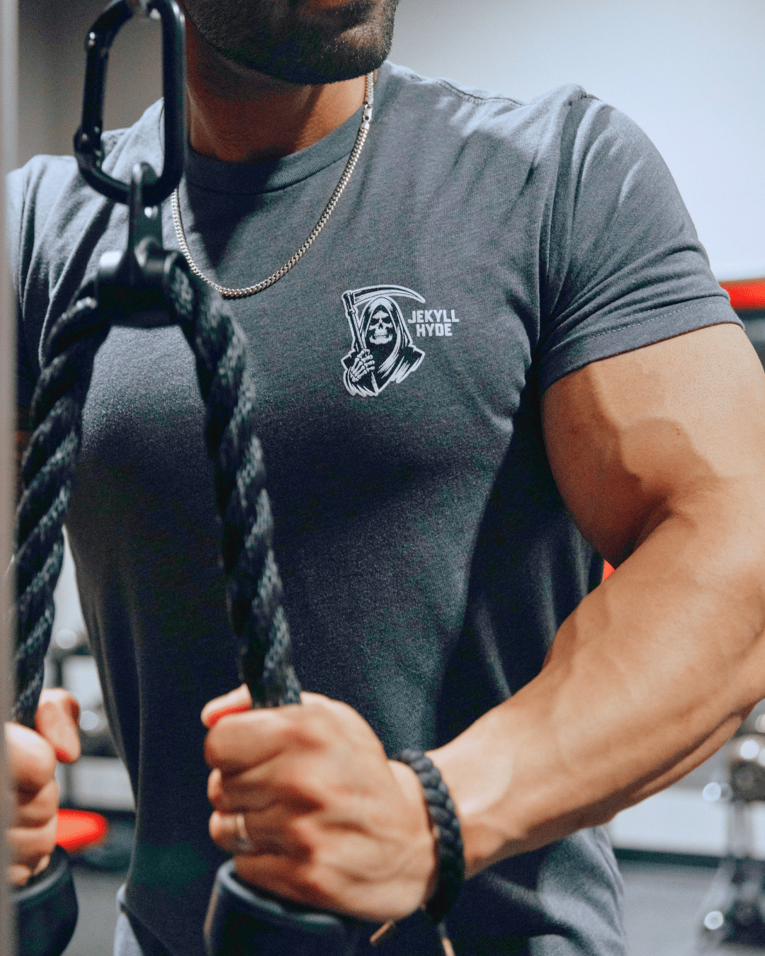 Man doing tricep pushdowns in grey tshirt
