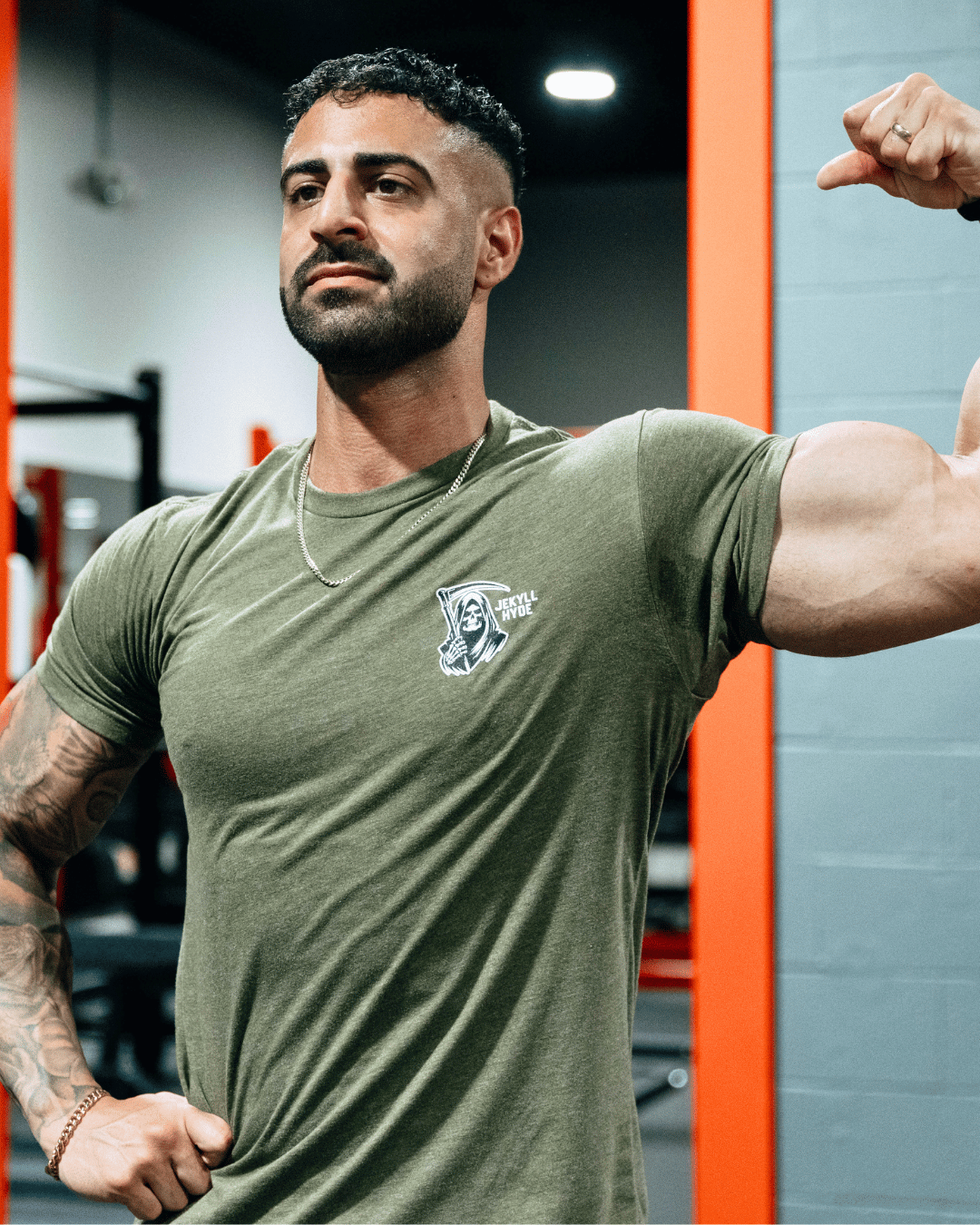 Man flexing in green tshirt
