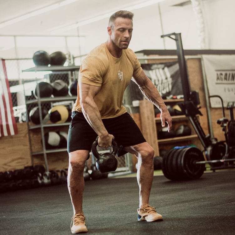 Man swinging a kettlebell with one arm