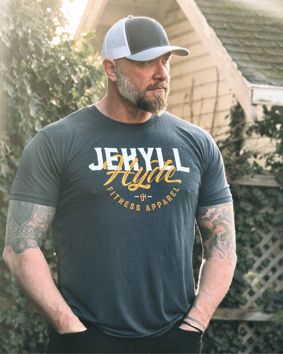 Man with his hands in his pockets wearing a Jekyllhyde tshirt. 
