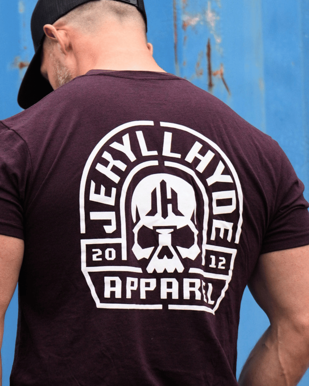Close up of the back of a maroon shirt with a white skull and jekyllhyde text on it. 