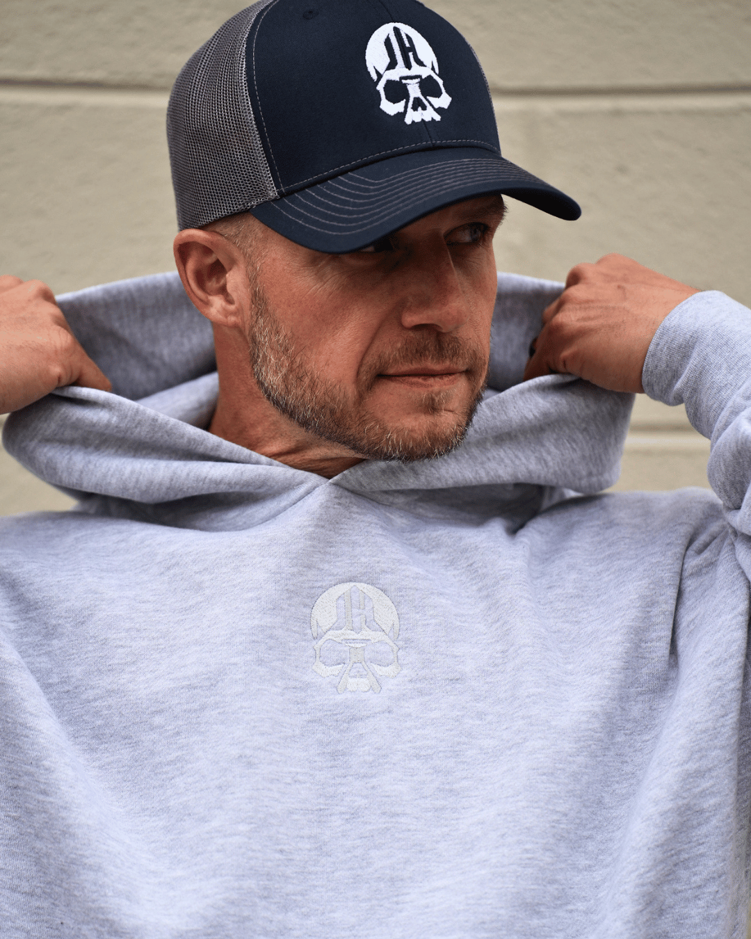 Man putting up a grey hood.