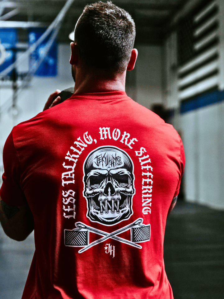 Man in a red shirt with a skull that has its mouth sewn shut. 