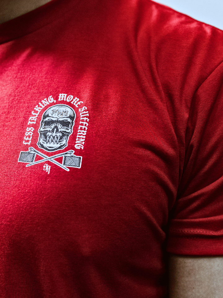 Red shirt with a left chest logo of a skull with its mouth sewn shut. 