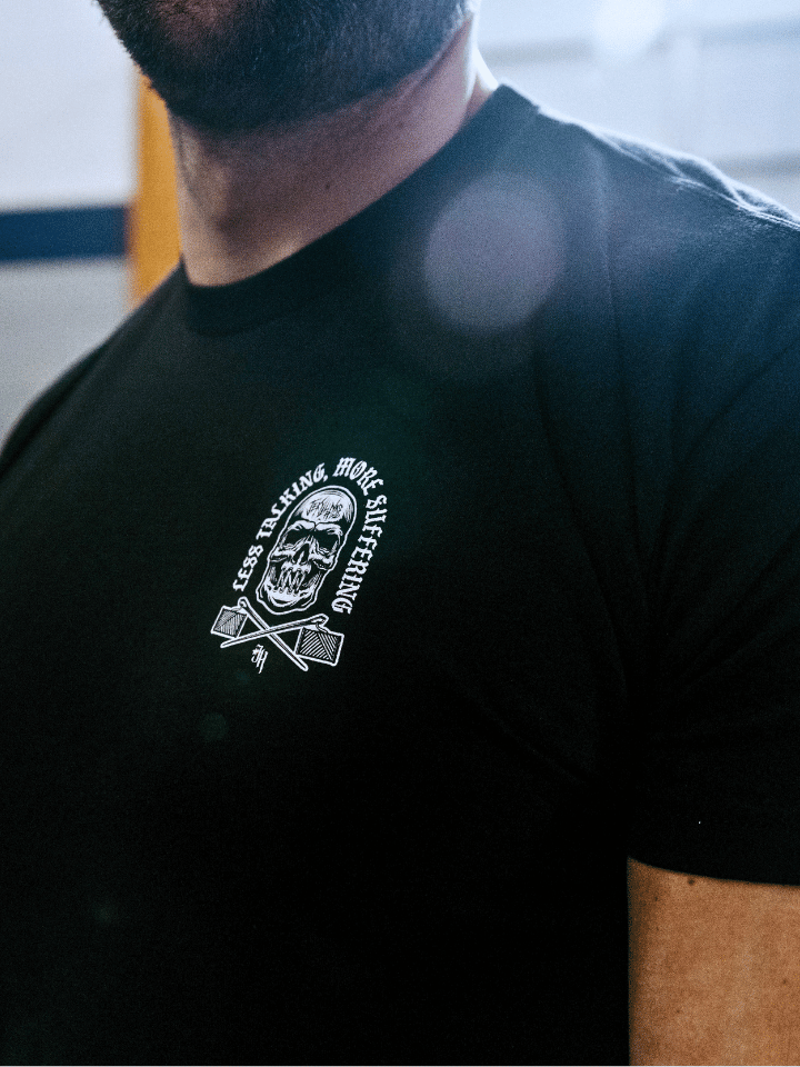 Black shirt with a left chest front logo of a skull with its mouth sewn shut. 