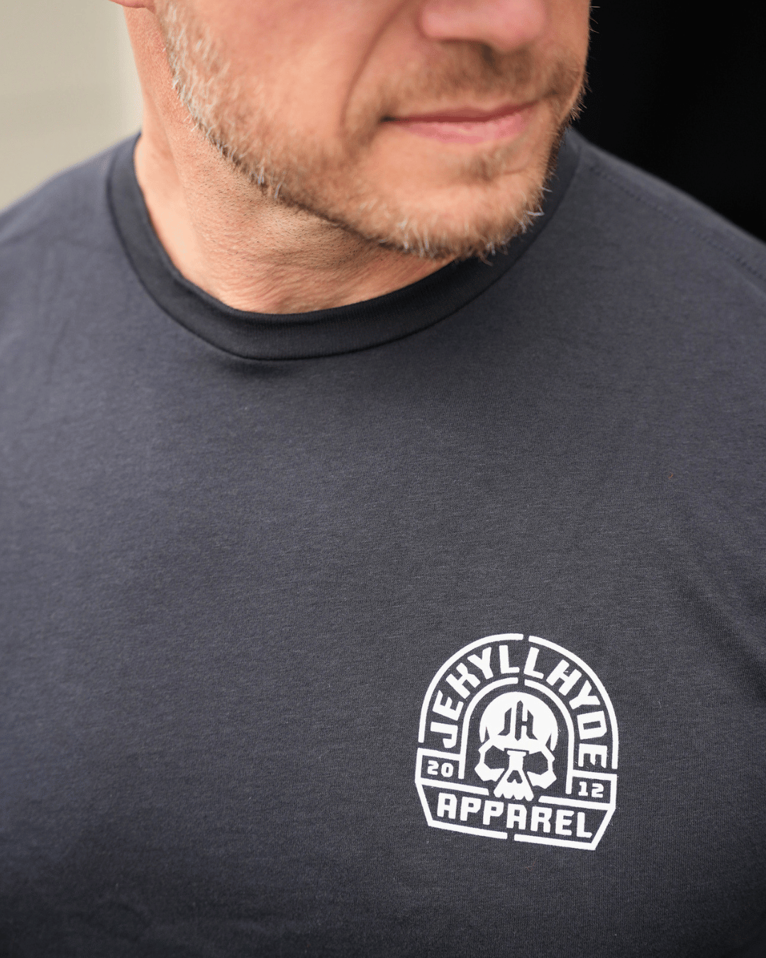 Close up of the left chest of a black shirt with skull and jekyllhyde design. 