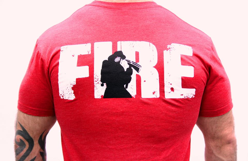 Back of a red shirt with a fireman holding an axe. 