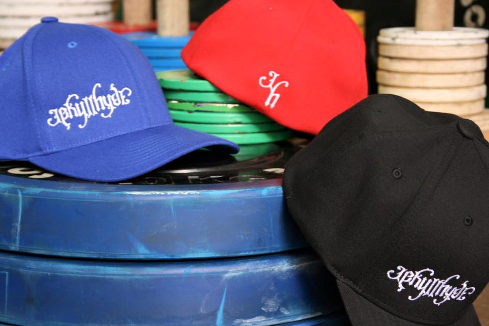 3 hats on a stack of weightlifting plates. 
