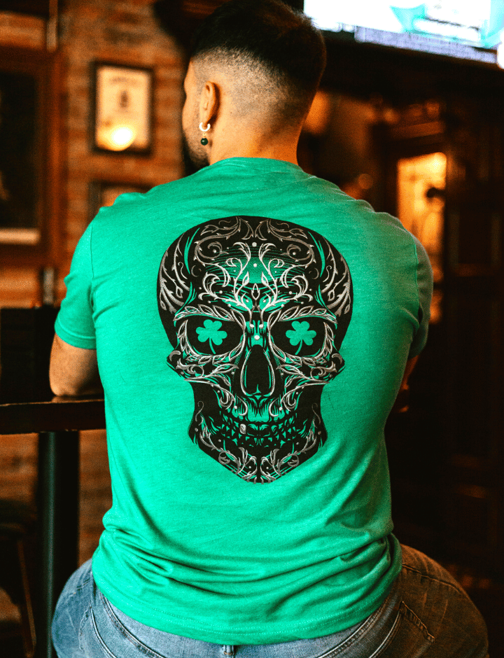 Man sitting at a bar with Shamrock skull tshirt.