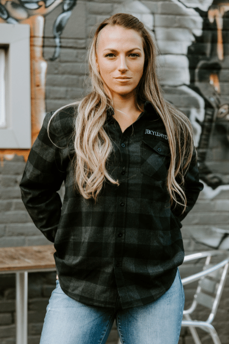 Woman in black flannel staring into the camera. 