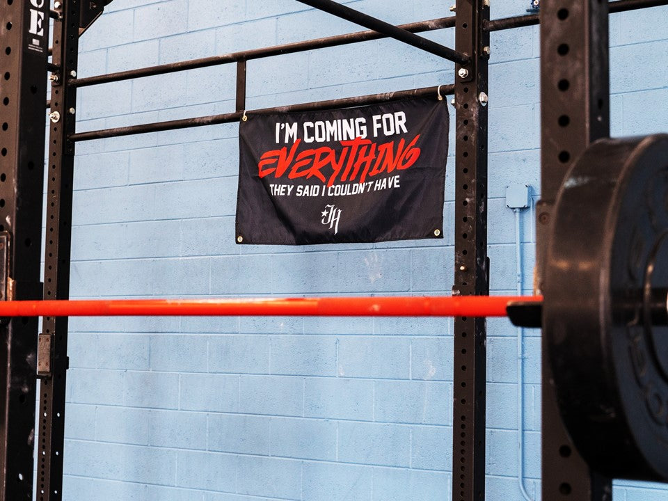 A black gym flag hanging from a pullup rig. 
