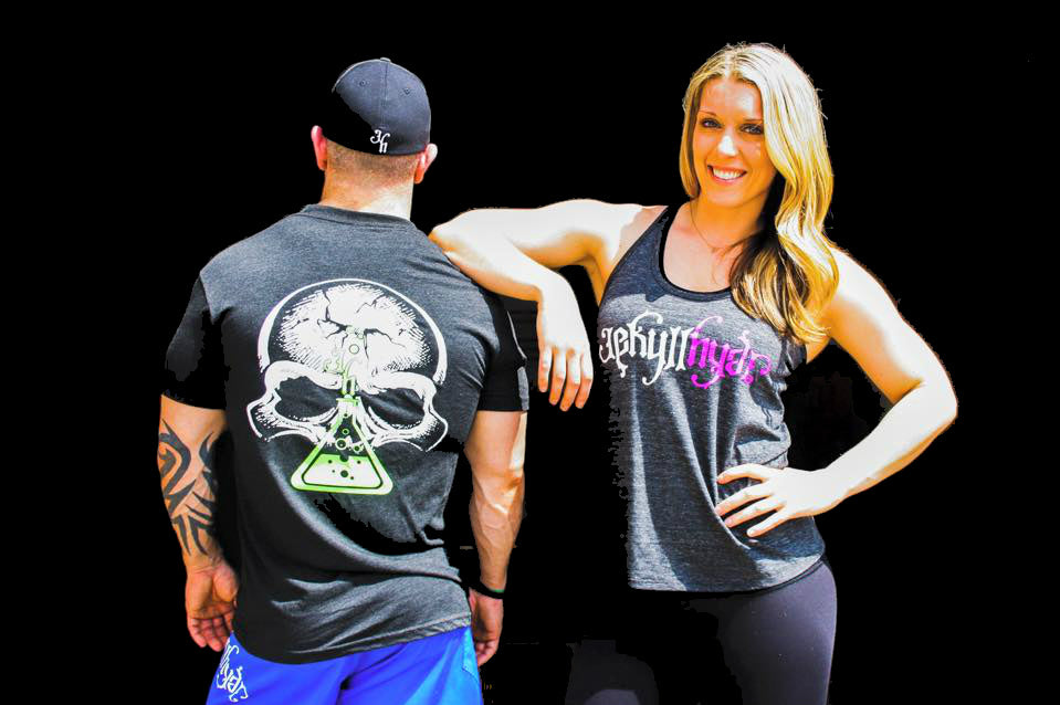 Man an woman standing together. Woman is facing the camera, man is facing away. 