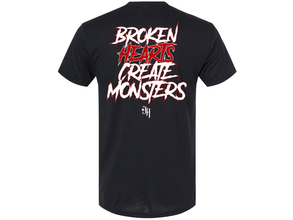 Back of a dary grey tshirt that reads "Broken hearts create monters" with a JH logo underneath the words. 