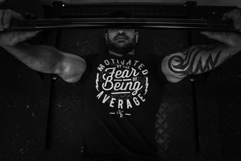 Man bench pressing, the image is in black and white. 