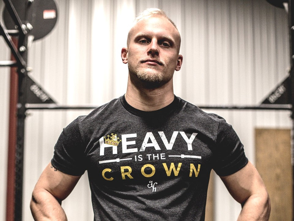 Man looking directly into the camera with a tshirt that reads "Heavy is the crown"