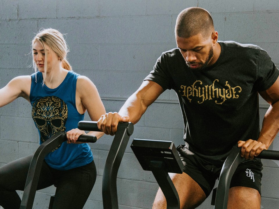 Man and woman on exercise bikes. 