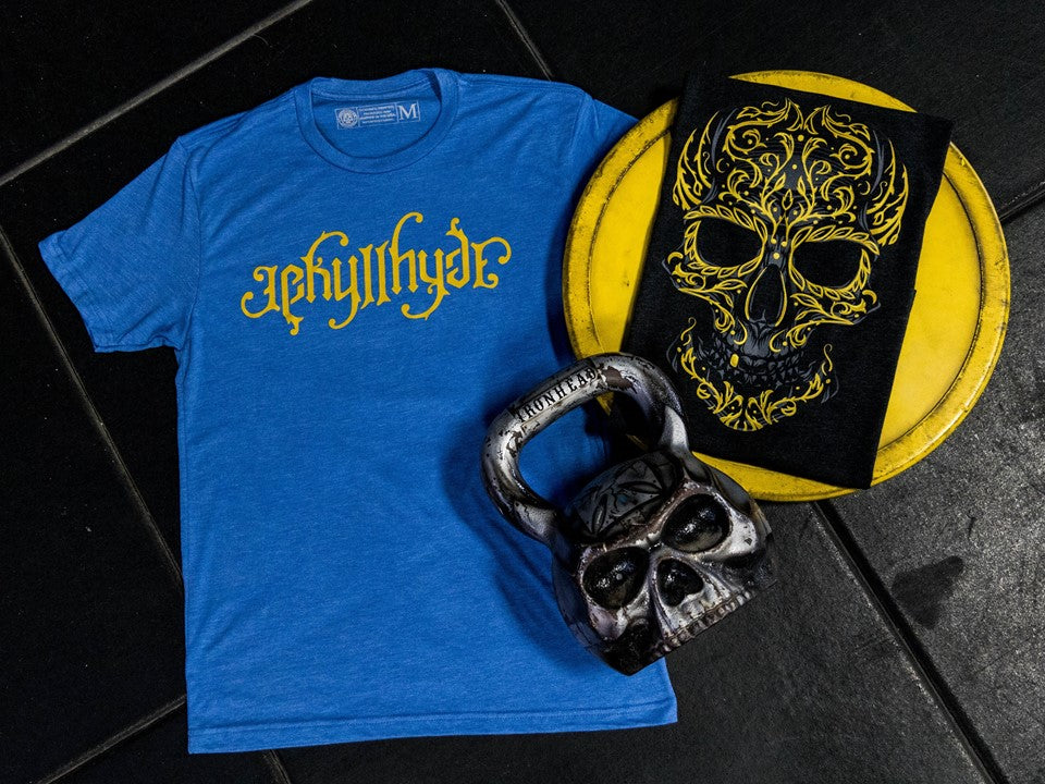 Flat lay of blue tshirt with a skull kettlebell. 