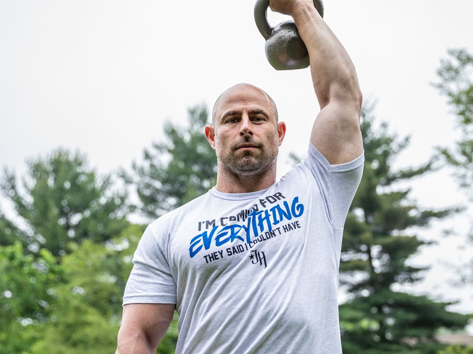 Man with a kettlebell overhead. 