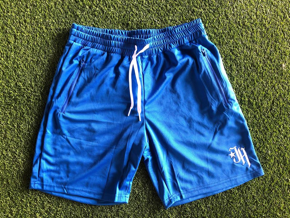 Blue shorts flat laid on turf. 