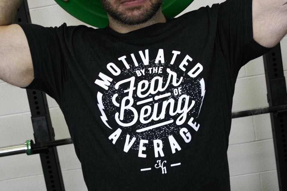Close up of a black tshirt with a motivational saying on it. 