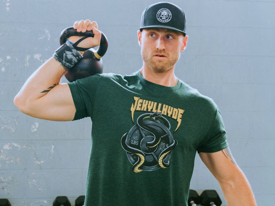 Man holding a kettlebell on his shoulder. 