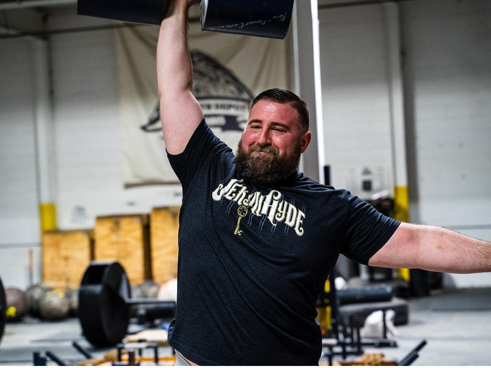 Strongman putting a heavy object overhead. 